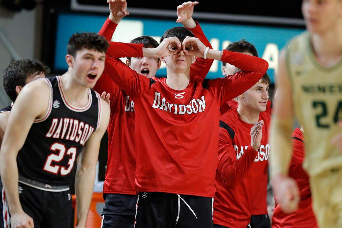 The Davidson Wildcats celebrate from the bench during a game against the Charlotte 49ers at Belk Arena in Davidson, N.C., Tuesday, Nov. 29, 2022.