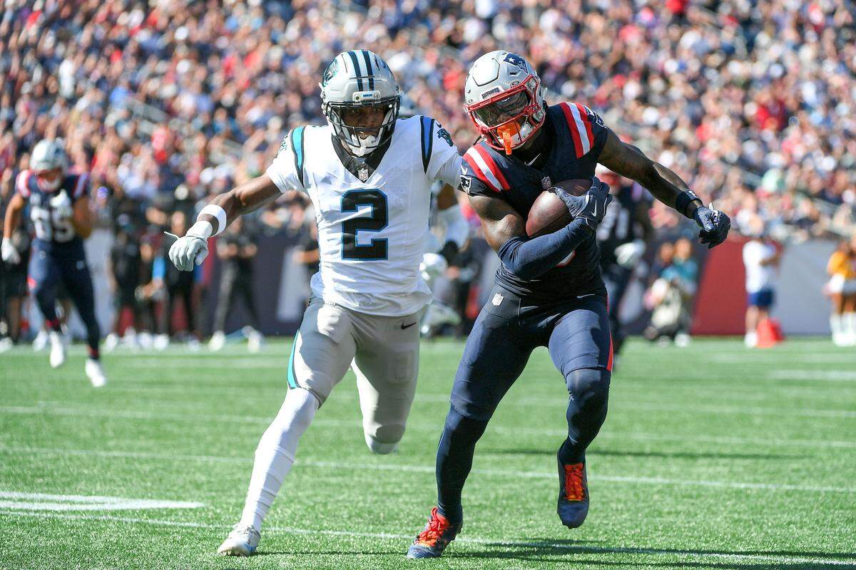New England Patriots wide receiver Stefon Diggs (8) runs the ball while Carolina Panthers cornerback Mike Jackson (2) defends during Sunday’s first half at Gillette Stadium.