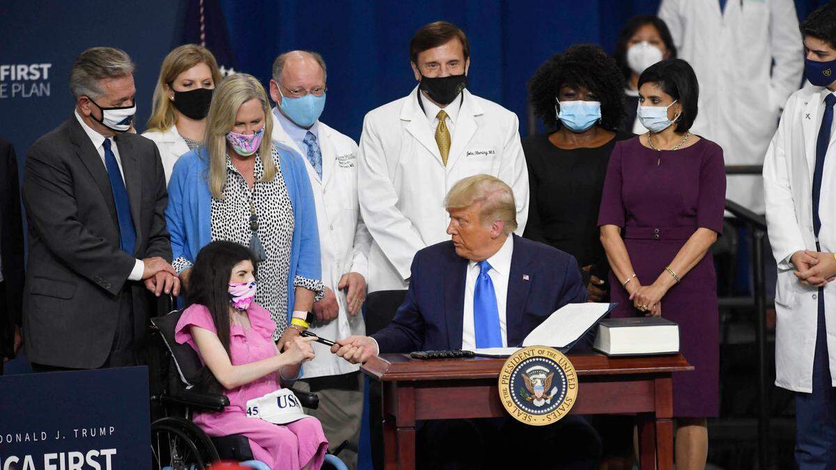 President Donald J. Trump gives away the pen he used to sign an Executive Order for the America First Healthcare Plan e in Charlotte on Thursday, September 24, 2020.