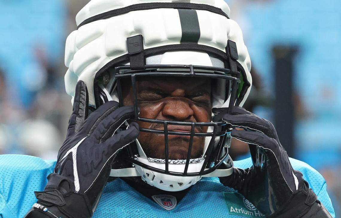 Carolina Panthers defensive tackle Marquan McCall scrunches his face as he pulls his helmet down during the team’s Fan Fest practice at Bank of America Stadium on Wednesday, August 2, 2023.