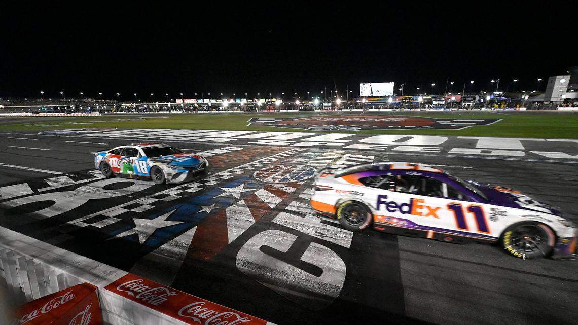 NASCAR driver Denny Hamlin crosses the finish line to win the Coca-Cola 600 at Charlotte Motor Speedway on Sunday, May 29, 2022. Hamlin held off Kyle Busch for the victory.
