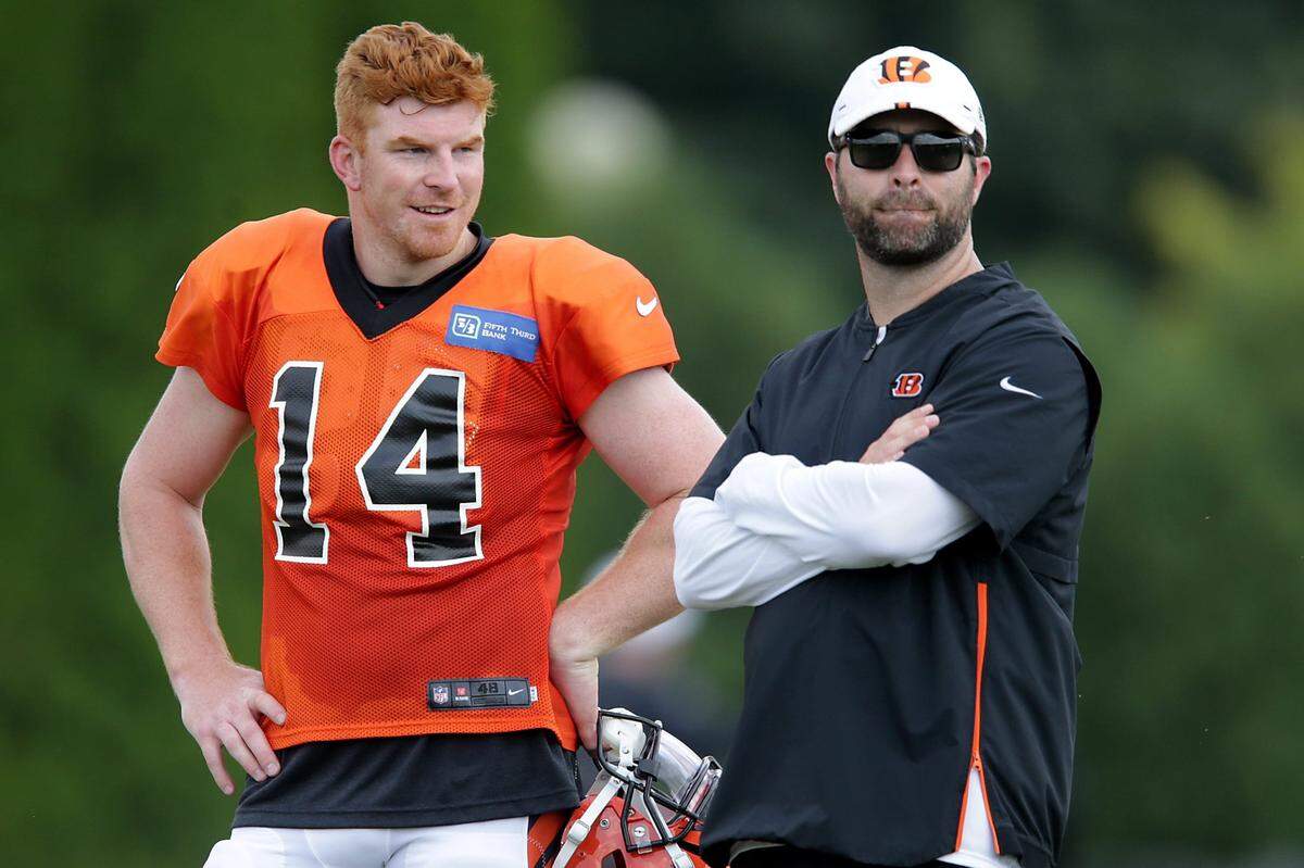 Cincinnati Bengals quarterback Andy Dalton (14), left, talks with Cincinnati Bengals offensive coordinator Brian Callahan during Cincinnati Bengals training camp practice, Wednesday, July 31, 2019, at the practice fields next to Paul Brown Stadium in Cincinnati.Cincinnati Bengals Training Camp July 31