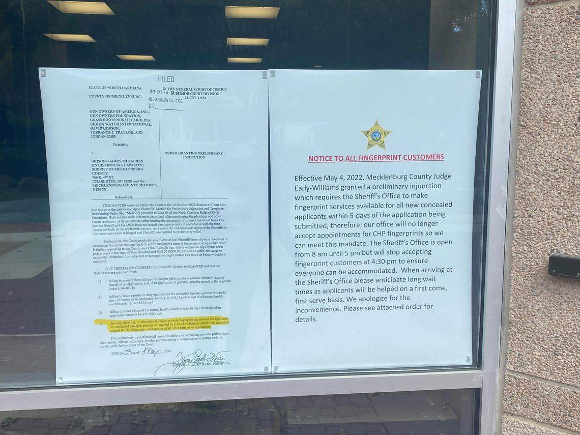 A sign posted in the front window of the Mecklenburg County Sheriff’s Office on Thursday, May 12, 2022, details the preliminary injunction issued by a Superior Court judge.