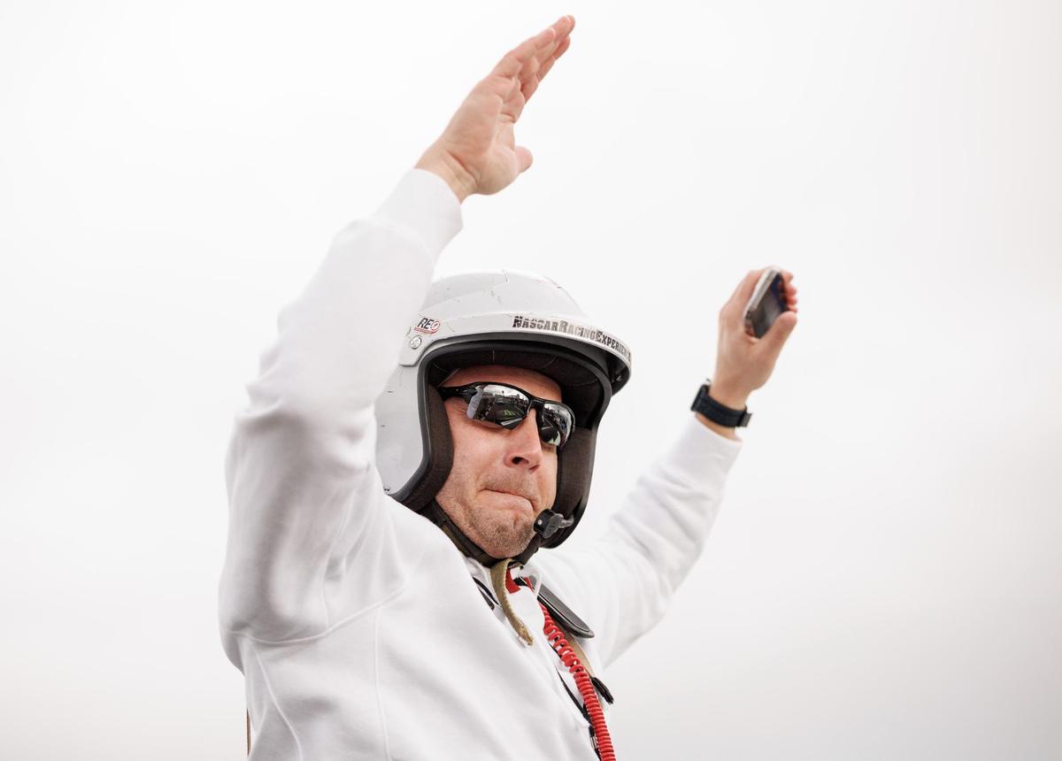 Minnesota head coach P.J. Fleck climbs from his race car after an experienced race car driver took him on several 160mph ‘Hot Laps’ at Charlotte Motor Speedway.