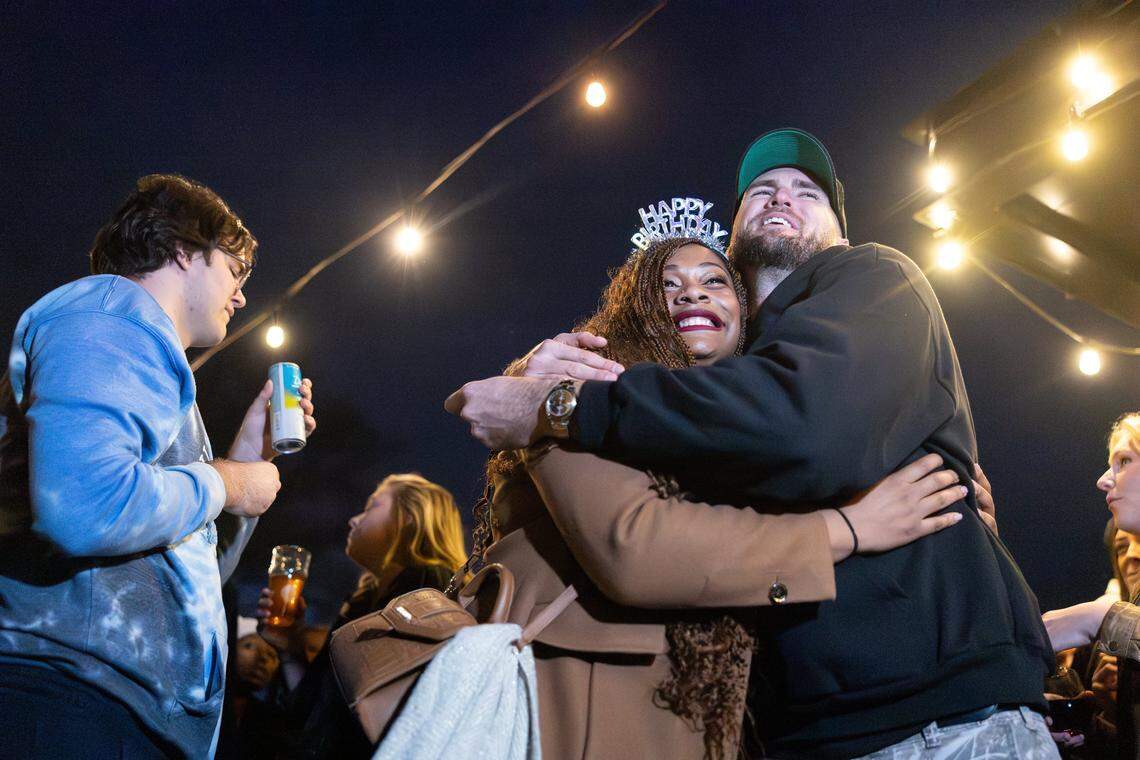 The 6-foot-9-inch, Tall Tour host, Tyler Bergantino, Tyler Bergantino, right, shares a hug with during the Tall Tour event at Brewers At 4001 Yancey in Charlotte, N.C., on Saturday, December 6, 2025.