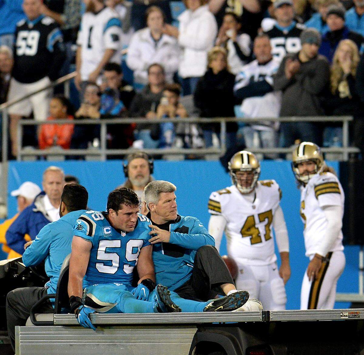 Carolina Panthers fans stood in 2016 as linebacker Luke Kuechly, left, was driven from the field in a cart after his second NFL concussion. He would suffer a third concussion in 2017. But in 2018 and 2019, Kuechly was concussion-free and played in all 16 Panthers games each year.