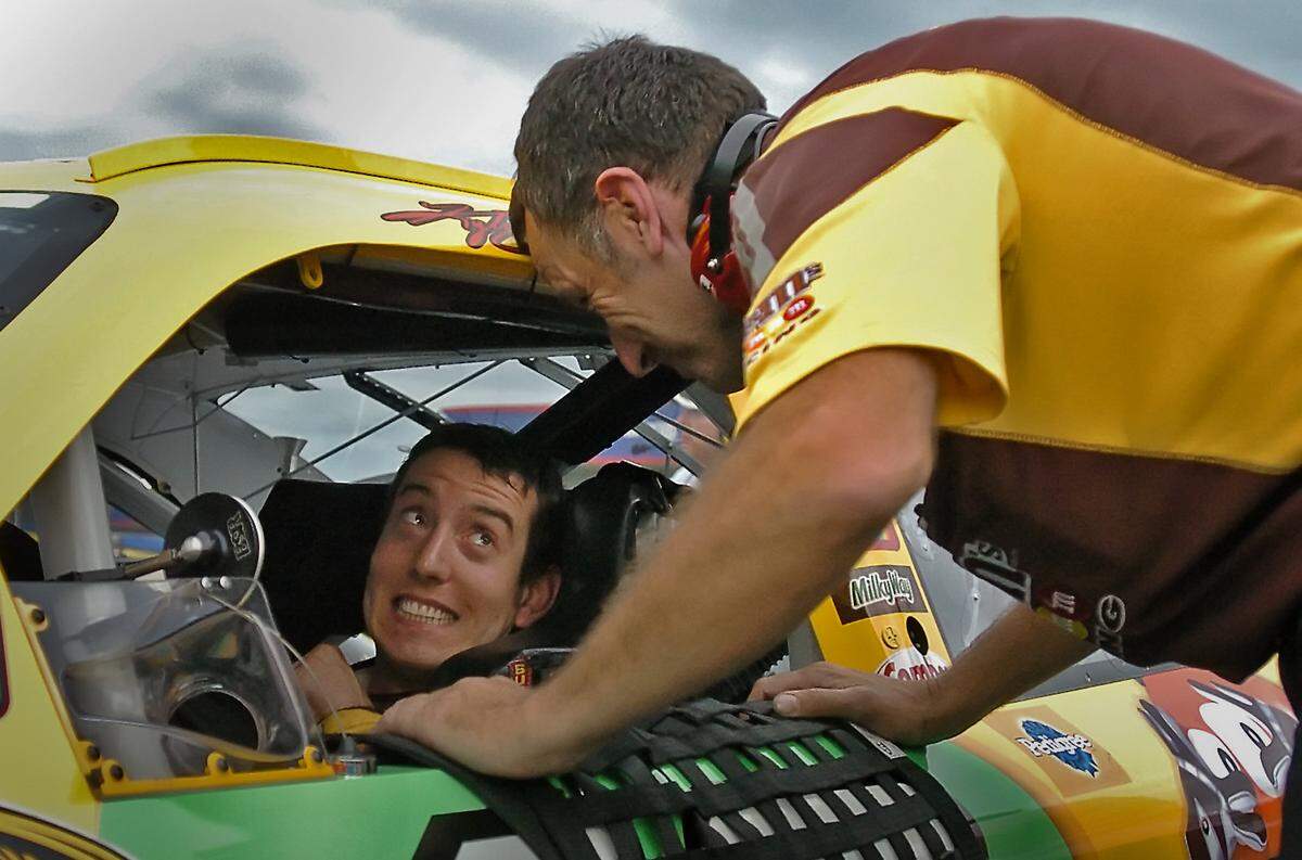 5/16/08 (L-R) NASCAR Sprint Cup Series driver Kyle Busch smiles at a crew member after winning the pole for the NASCAR Sprint All Star Race at Lowe's Motor Speedway. The race will be run on Saturday, May 17th. Driver Jeff Gordon qualified second.  JEFF SINER -- jsiner@charlotteobserver.com