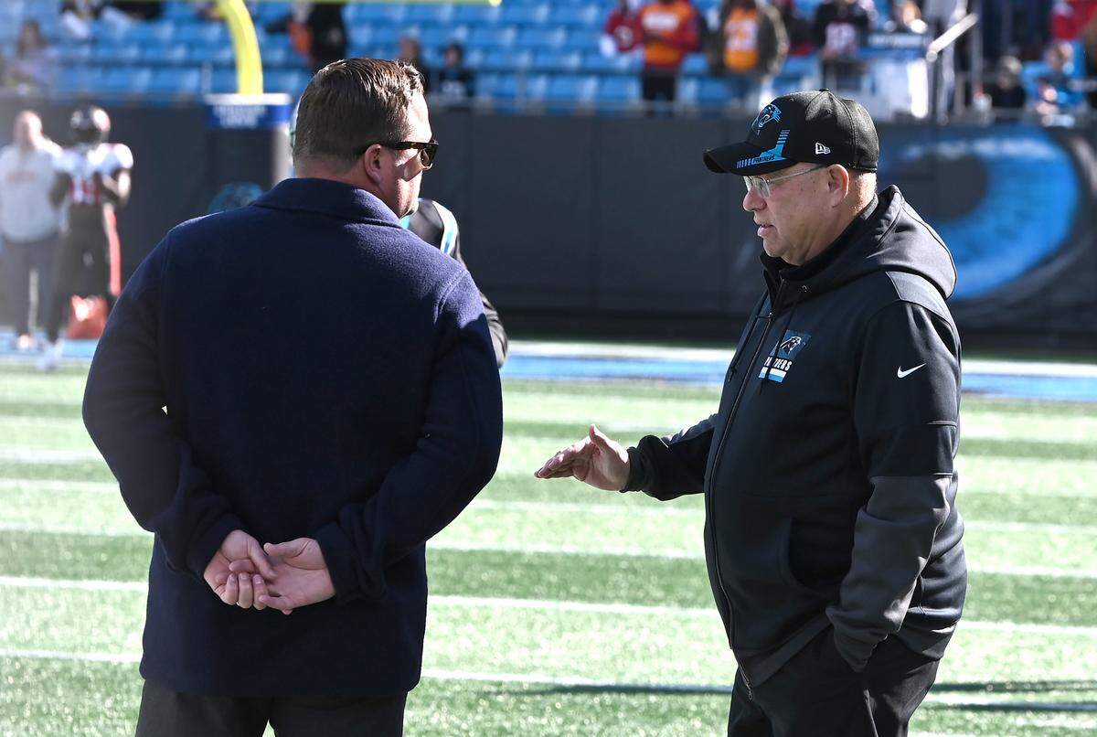 Carolina Panthers general manager Scott Fitterer, left, speaks with team owner David Tepper along the team’s sideline during pregame activities at Bank of America Stadium in Charlotte, NC on Sunday, January 7, 2024. The Tampa Bay Buccaneers defeated the Panthers 9-0. Fitterer was fired by after three seasons on Monday, January 8, 2024.