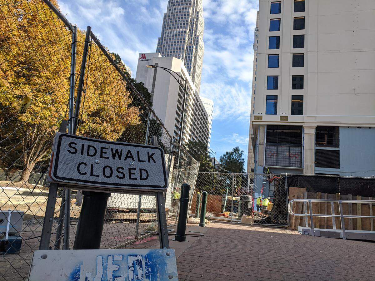 A sidewalk closed sign in front of the 24-floor Carillon building and Morton’s the Steakhouse at 227 W. Trade St. in Charlotte.