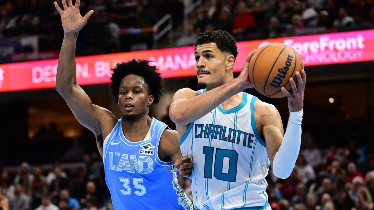 Nov 17, 2024; Cleveland, Ohio, USA; Charlotte Hornets guard Josh Green (10) drives to the basket against Cleveland Cavaliers forward Isaac Okoro (35) during the first half at Rocket Mortgage FieldHouse. Mandatory Credit: Ken Blaze-Imagn Images