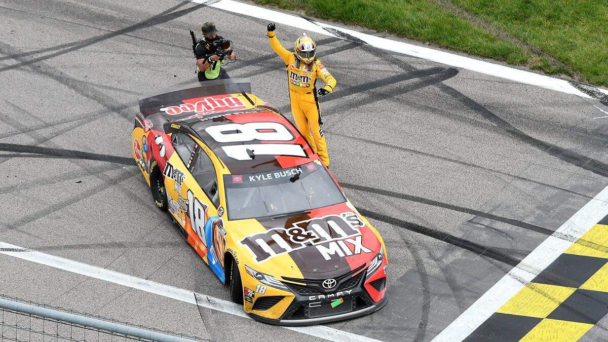 Kyle Busch celebrates after winning the NASCAR Buschy McBusch Race at Kansas Speedway in May 2021.