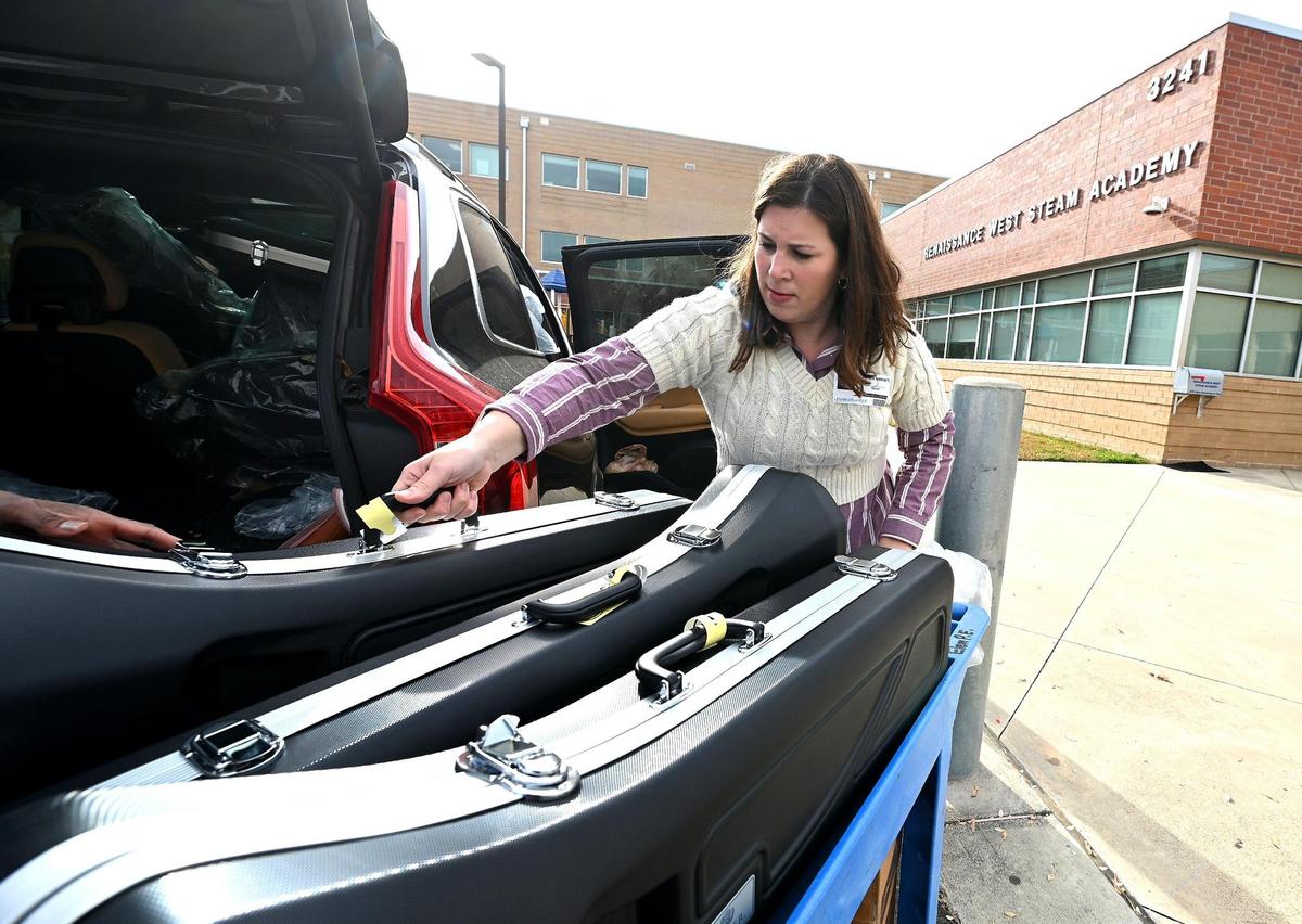 Lauren Harnett, executive director of Jane’s Fund, unloads musical instruments and other supplies for students at Renaissance West STEAM Academy last month. Jane’s Fund provided approximately $65,000 worth of instruments to the school.