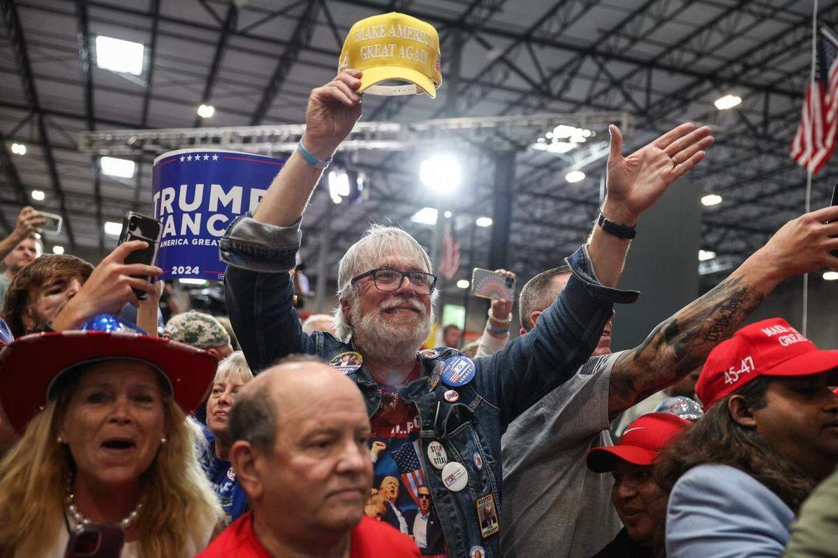 Supporters watch as Former President Donald Trump leaves a campaign rally inside the Mosack Group manufacturing warehouse in Mint Hill, NC on Wednesday, September 25, 2024.