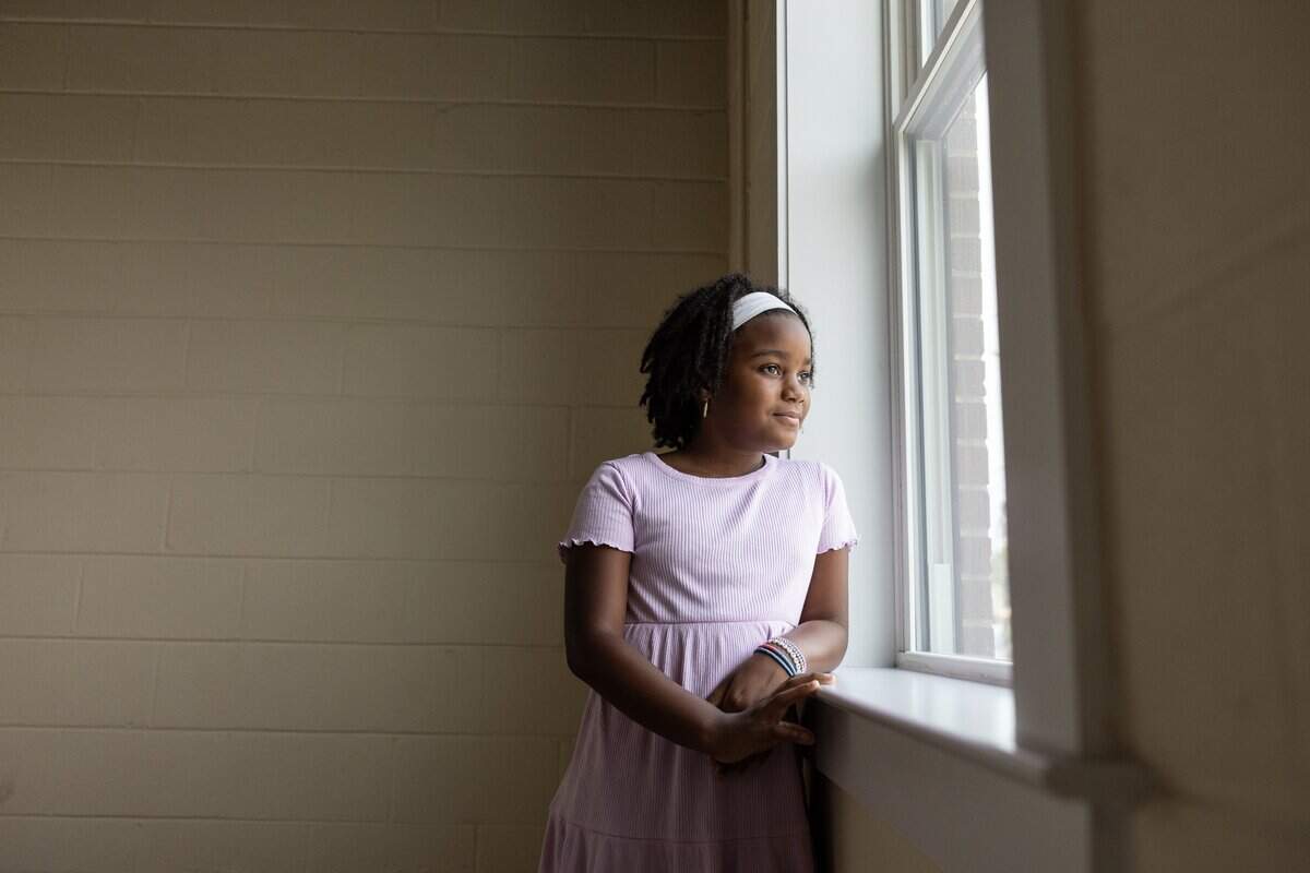 Titiana Vandyke, 8, looks out the window of her bedroom in  her new apartment during WeBuild Concord’s ribbon-cutting ceremony for The Sanctuary Apartments in Concord, N.C., on Tuesday, July 14, 2026.