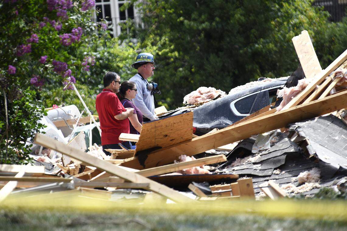 Two people, possibly relatives of the home owners, talk with an ATF investigator amidst the debris after a Tuesday explosion of a home in Ballantyne. Investigators from ATF, CFD and CMPD dug through the rubble of a home Ballantyne Wednesday, July 3, 2019. An explosion destroyed the south Charlotte house Tuesday afternoon, authorities said, and left one person dead and another with life-threatening injuries. The house in the 11000 block of James Jack Lane was last sold for $1.27 million in 2 015, county records show.