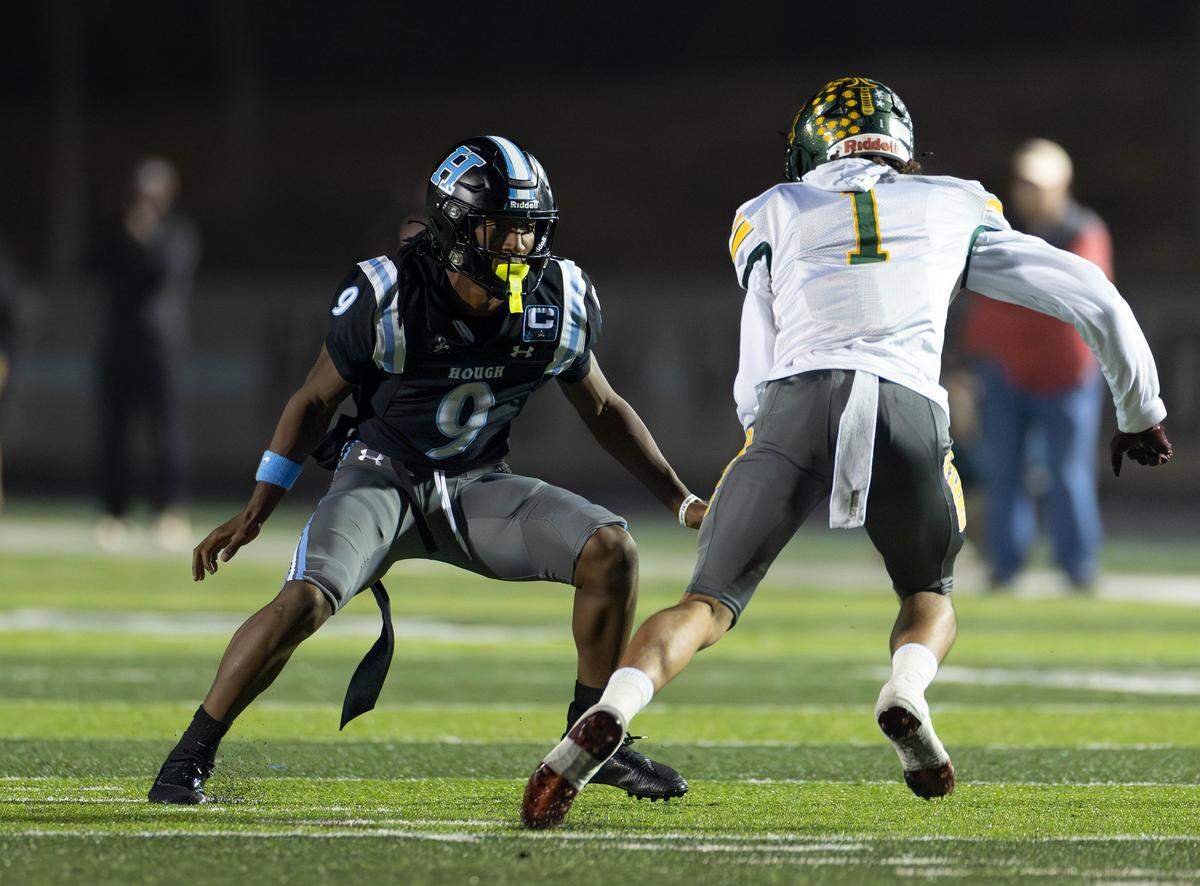 Hough senior defensive back Samari Matthews (9) defends West Forsyth's Jaylin Moore (1) during first-quarter action of their Nov. 21, 2025 NCHSAA 8A playoff game. 