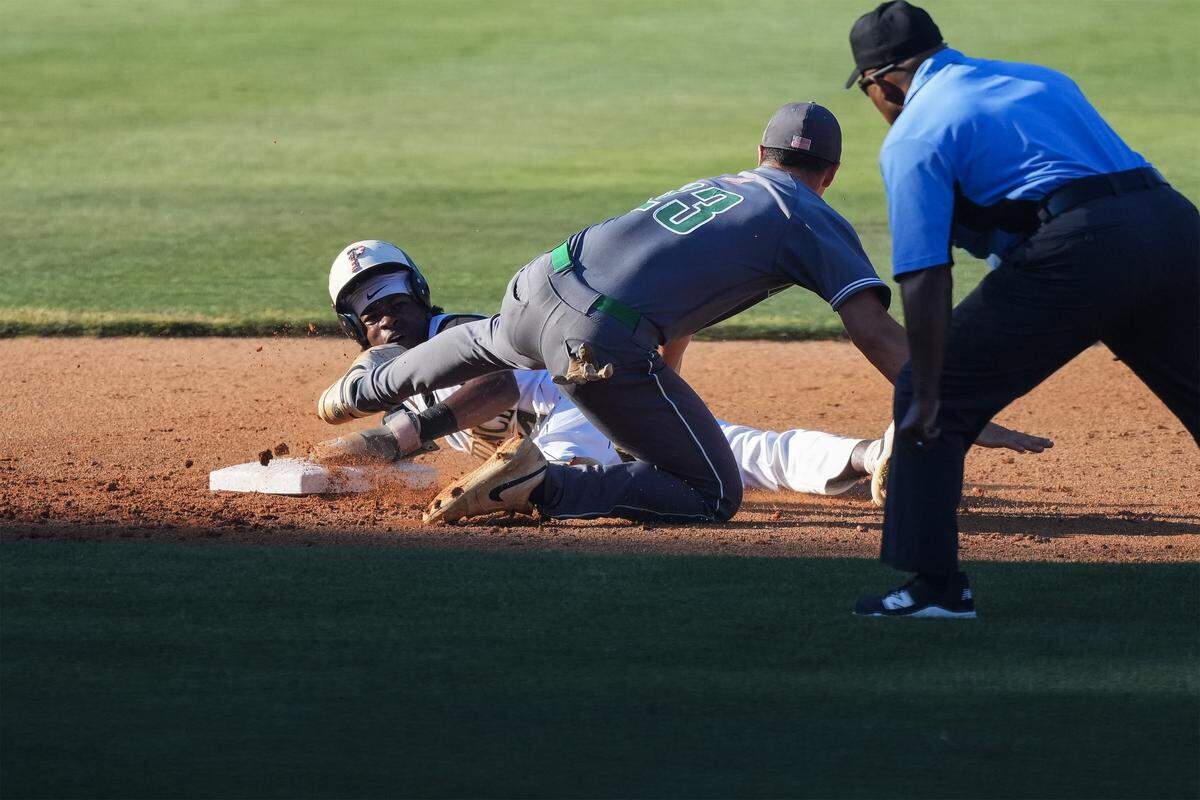Providence’s Jaxon Haynes (14) avoids the tag from Myers Park’s Evan Howard (23) during the first inning of a NCHSAA playoff baseball game, Tuesday, May 19, 2026, in Charlotte, N.C. 