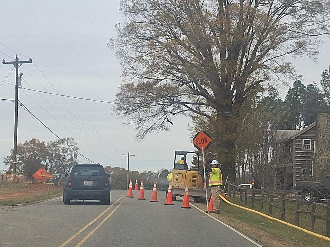 Construction workers on Rinehardt Road in Mooresville held “Stop” and “Slow” signs to let large construction trucks into and out of the massive Cambrey Pointe site on Thursday, Nov. 13.
