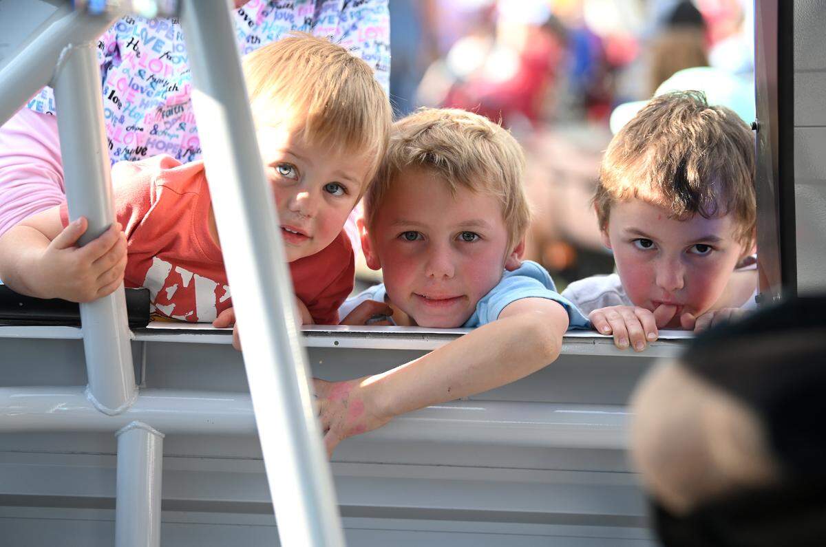 Brothers Malachi, Mason and Myles Elvis peer into a NASCAR XFINITY Cup Series car during Thunder Fest in downtown Rockingham on Thursday evening that featured former NASCAR drivers Kenny Wallace and Ken Schrader along with NASCAR Craftsman Truck Series and XFINITY Series drivers. NASCAR action is returning to Rockingham Speedway this weekend.