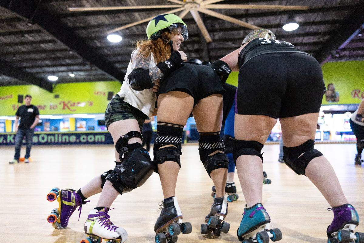 Clarissa “Lacy Lawless” Lacy pushes past blockers during a jam at Charlotte Roller Derby practice at Kate’s Skating Rink in Indian Trail, N.C., on Sunday, July 30, 2023.