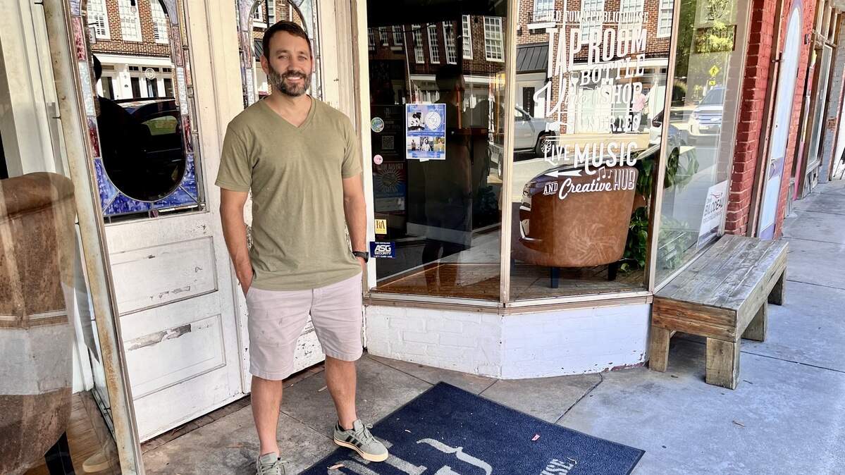 Owner Case Warnemunde poses outside Old Town Public House in downtown Cornelius on Thursday, Oct. 2, 2025. The popular nightlife venue will close in January before the building is demolished for a major new development project.
