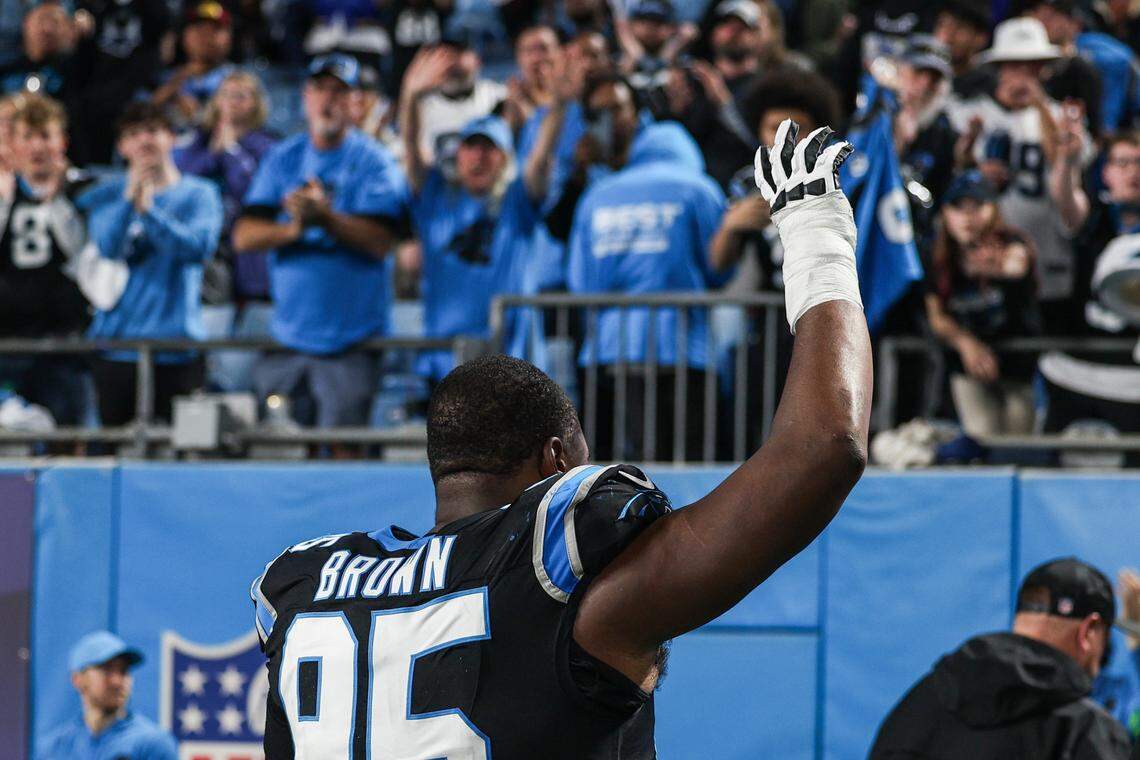 Panthers defensive tackle Derrick Brown waves to fans as he runs off the field after a loss to the Rams, 34-31, in the wild card playoff game at Bank of America Stadium in Charlotte on Jan. 10, 2026.