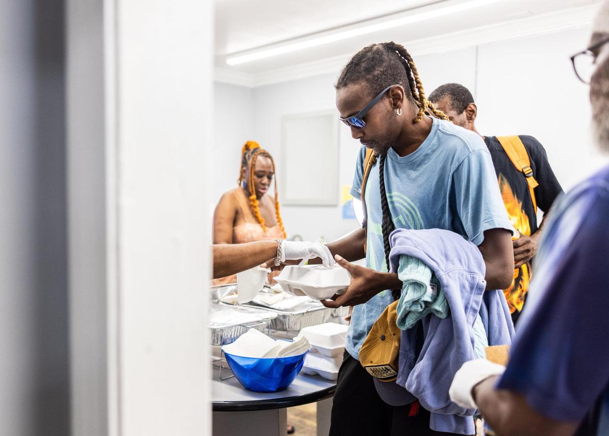 Antonio McCall receives a boxed lunch at Hajee House Harm Reduction in Charlotte on July 17.