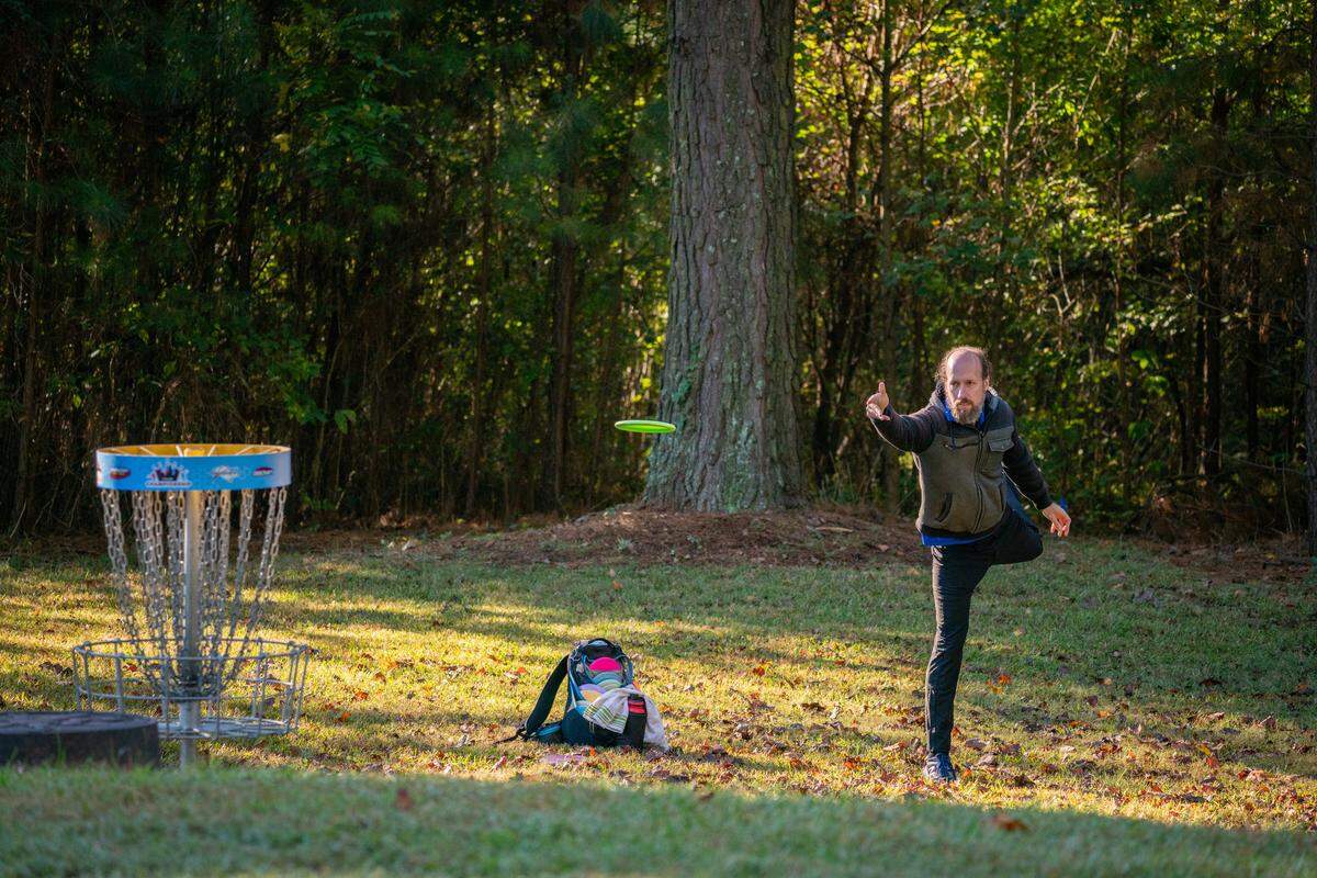 Professional disc golfer Michael Johansen puts on the green of Hole 6 at Hornet’s Nest Park.