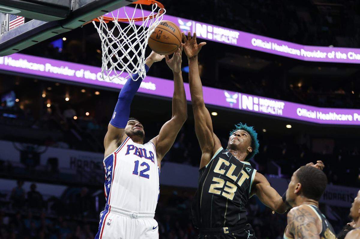 Charlotte Hornets forward Kai Jones (23) knocks the ball away from Philadelphia 76ers forward Tobias Harris (12) during the first half at Spectrum Center. 