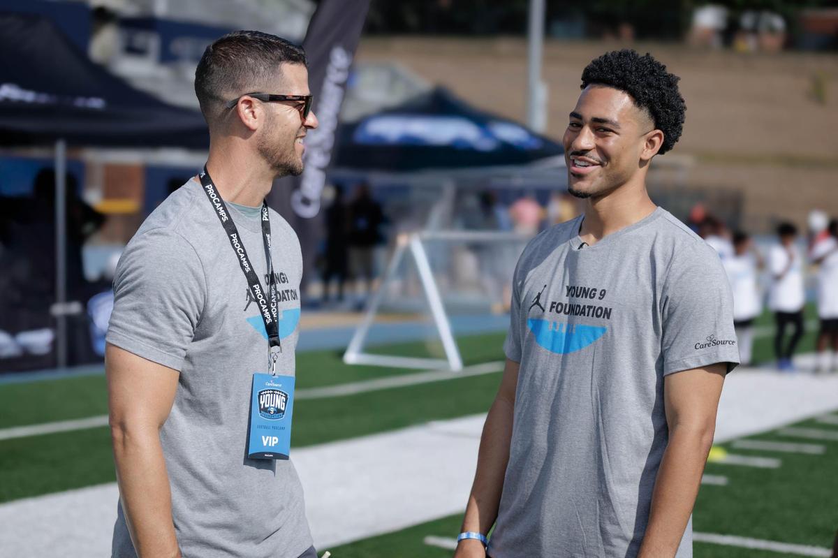 Carolina Panthers head coach Dave Canales (left) and quarterback Bryce Young (right) prepare to lead over 300 youth football campers at the Caresource Bryce Young Football ProCamp hosted at Johnson C. Smith University Saturday, June 7, 2025.