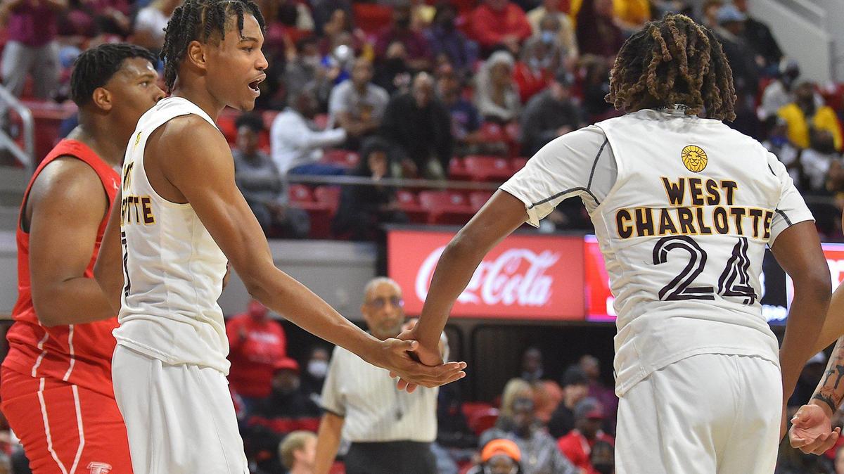 West Charlotte’s Chancellor Morrow (3) celebrates with Landon King (24) after a play. The West Charlotte Lions and the Fayetteville Seventy-First Falcons met in the NCHSAA Boys Basketball 3A Championship Game in Raleigh, N.C. on March 12, 2022.