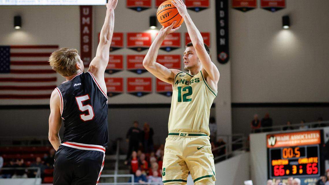 Charlotte 49ers guard Jackson Threadgill (12) shoots the game winning basket over Davidson Wildcats guard Grant Huffman (5) during a game at Belk Arena in Davidson, N.C., Tuesday, Nov. 29, 2022.