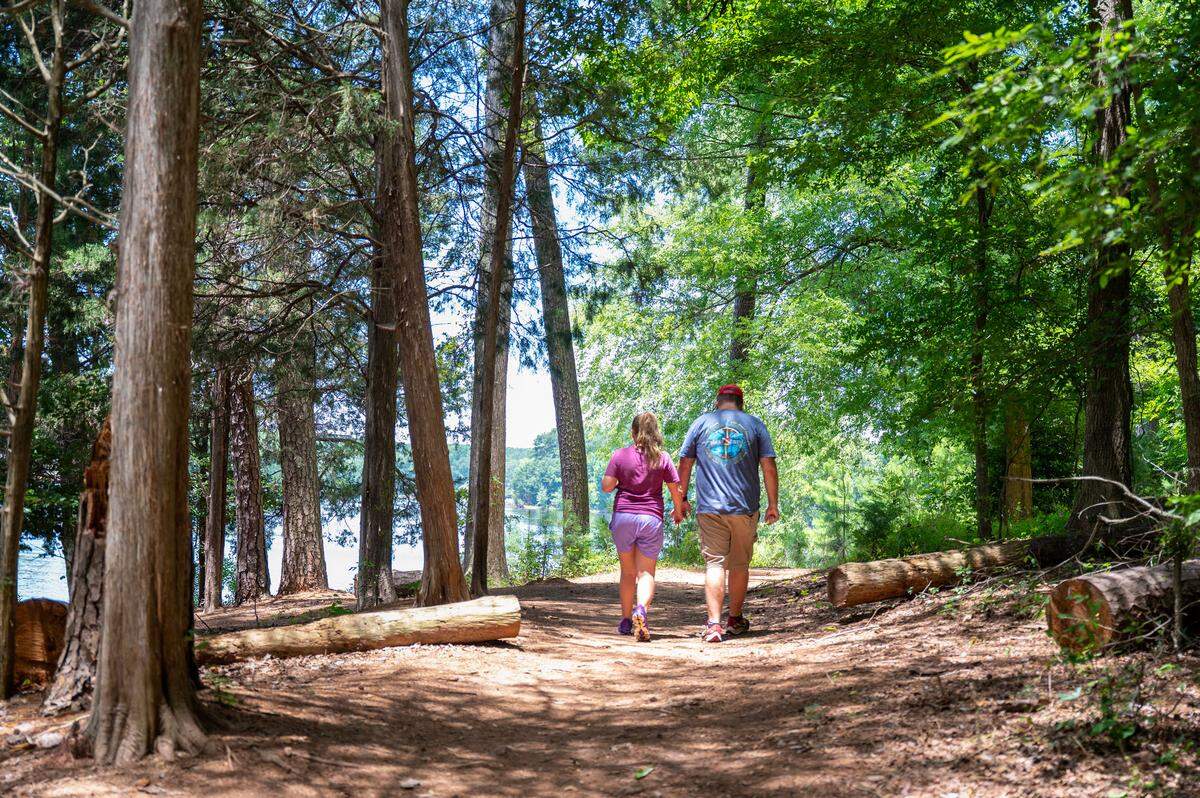 A bill approved by the North Carolina legislature would add the South Fork Passage to the state trail system. In this photo, Jonathan Newell walks with his daughter Aubrey France along the Duke Kimbrell Trail portion of the Carolina Thread Trail in Belmont, NC, Thursday July 3, 2025.