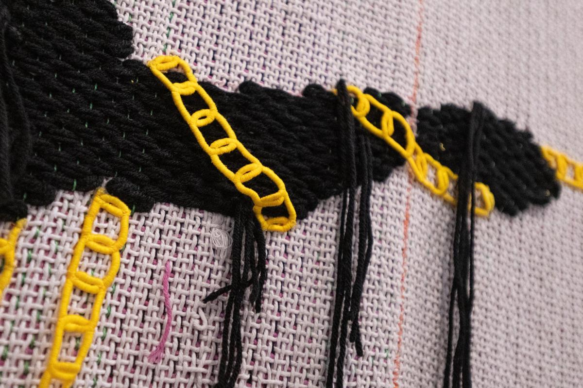 Diedrick Brackens tapestry titled “brotherhood is fragile” hangs on display in the Diedrick Brackens: ark of bulrushes exhibit of textiles, photography and basketry at Mint Museum Randolph.