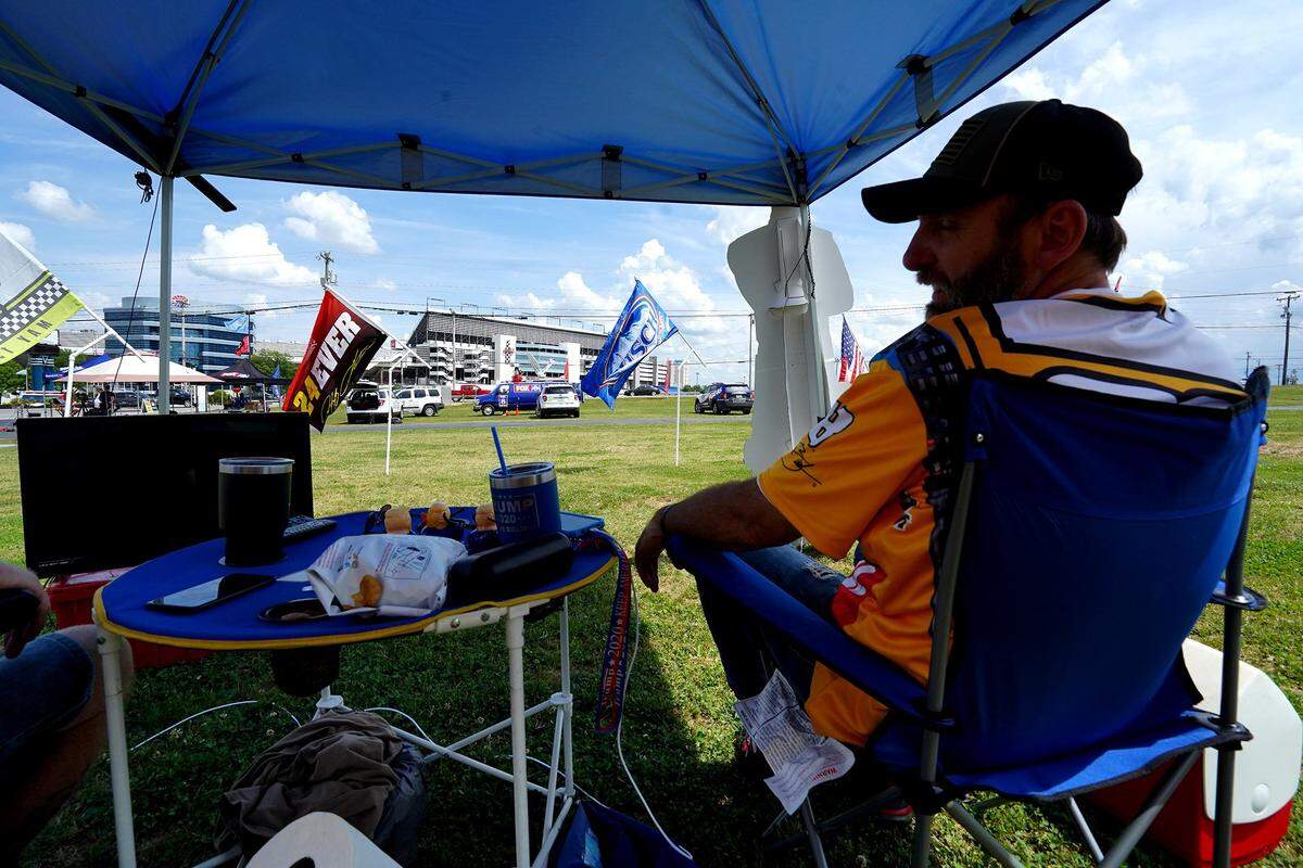 NASCAR fan Larry Bickley of Charlotte, NC sits inside the tent that he and friend David Magnussen set up outside Charlotte Motor Speedway on Sunday, May 24, 2020. Despite not being allowed to attend the Coca-Cola 600 in person due to COVID-19 regulations, Bickley and Magnussen showed up in hopes of hearing the cars and smelling the rubber. The tent featured a flat screen tv, Sirius radio along with chairs and drinks.