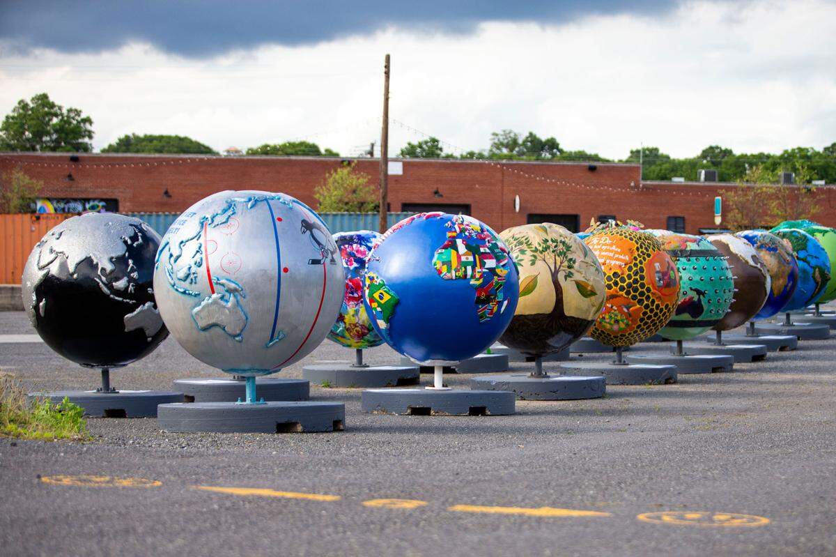Dozens of globes wait at Camp North End before they were installed throughout Charlotte as part of a traveling public art exhibition called “Cool Globes.” The exhibition includes 35 globes, each with a climate change message. Seven were created by Charlotte artists.