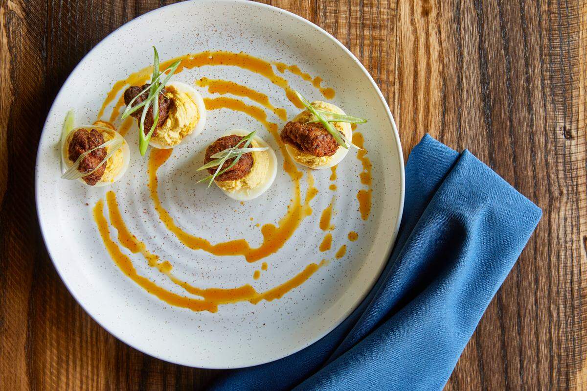 Golden Owl Tavern’s Deviled Eggs are topped with a nugget of Nashville hot chicken.