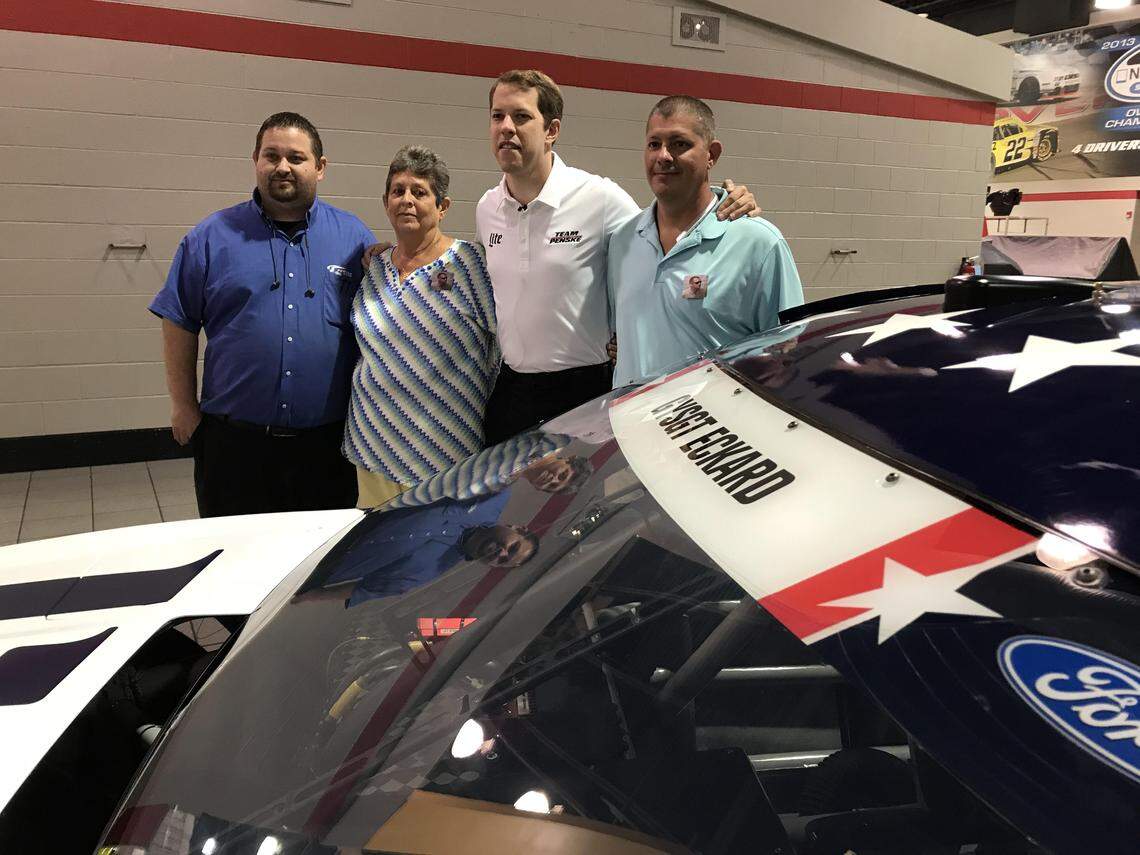Casey Mahoney, Eunice Eckard, Brad Keselowski and Chad Eckard (from left to right) unveil the car Keselowski will drive during Coca-Cola 600 to honor Chris Eckard. Mahoney and Eckard were childhood friends, and he suggested Eckard be honored on Keselowski's car during 600 Miles of Remembrance at the Coca-Cola 600.