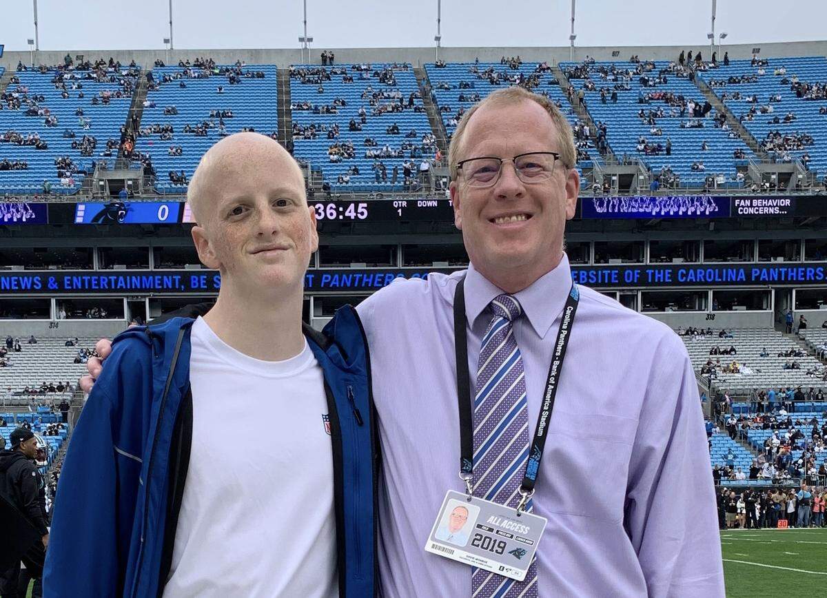 Noah Monroe (left) says he was inspired by his father David (right) to enter the journalism field. David Monroe is now the team historian for the Carolina Panthers.