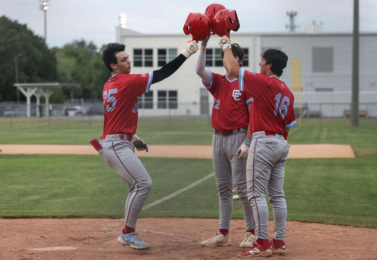 Catholic’s Alex Hoffman , left, celebrates a home run with teammates as he runs across home plate during the Southwestern 4A championship baseball game at Garinger High School in Charlotte, NC on Thursday, May 1, 2025.