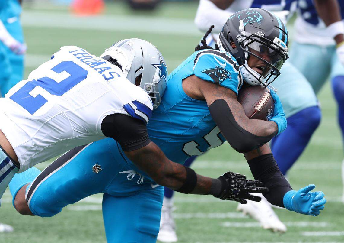 Carolina Panthers running back Rico Dowdle fights for yardage during Sunday’s game against the Dallas Cowboys in Charlotte. 