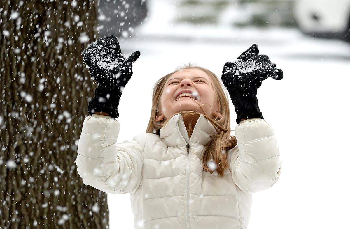 Here for a cheer competition at the Charlotte Convention Center, Jhett Lauer of Tallahassee, Fl., enjoys the wintry mix of rain, sleet and snow along Stonewall Street on Sunday in January 2022.