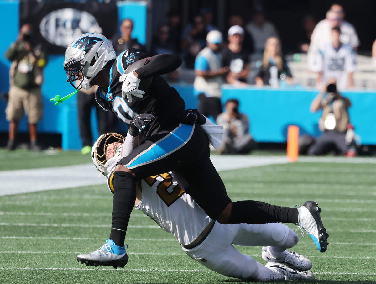 Carolina Panthers’ Ja'Tavion Sanders is tackled by New Orleans Saints’ Pete Werner during the first quarter on Sunday at Bank of America Stadium.