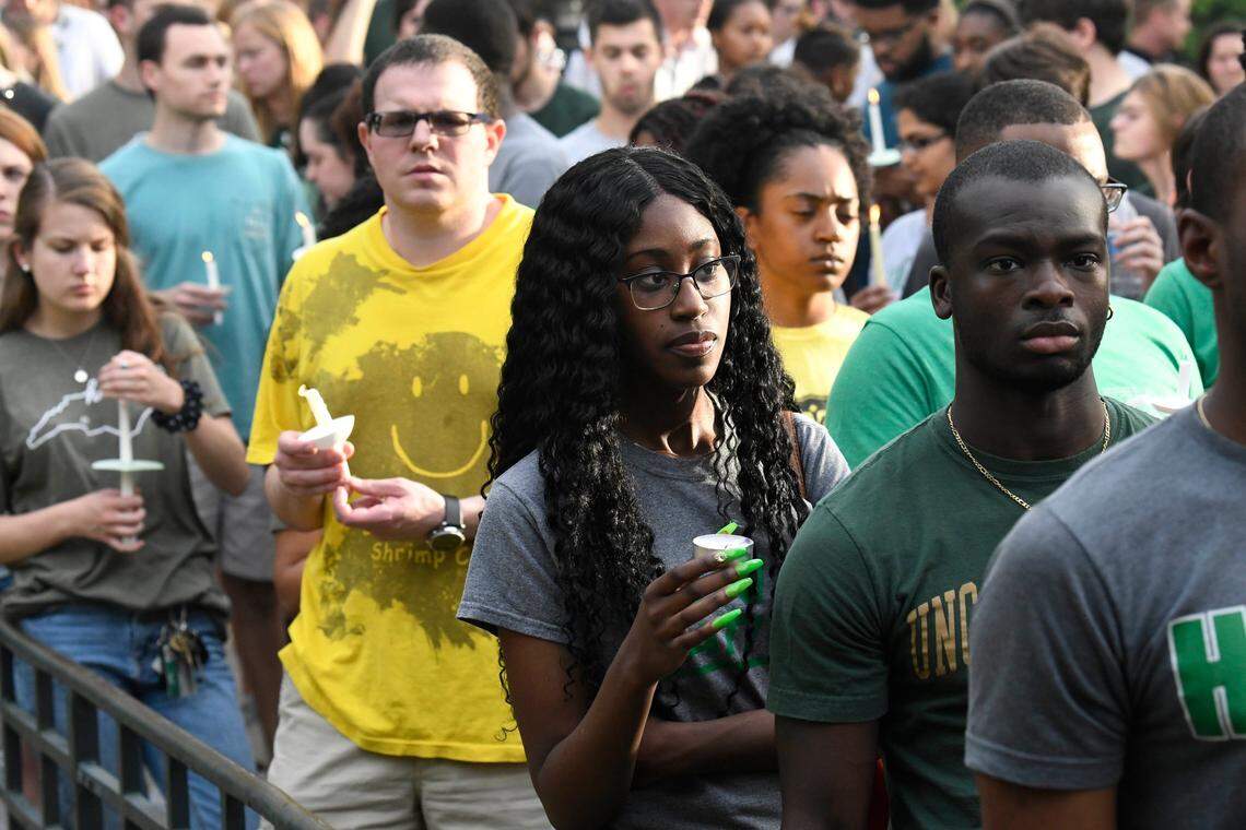 UNC Charlotte students light candles during a vigil on Wednesday, May 1, 2019 in memory of the students killed during a campus shooting on Tuesday.