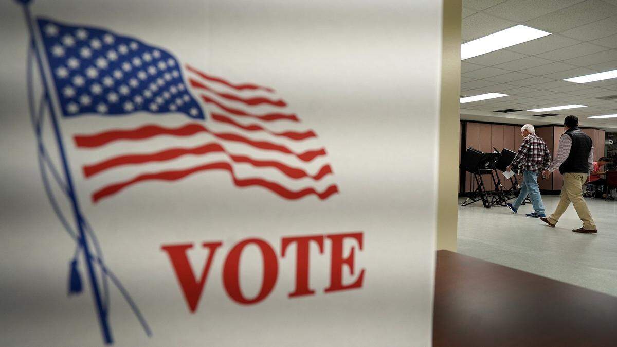 Precinct Official Ed King right/front, leads a voter to a machine to cast their ballot at Precinct #48 at Providence United Methodist Church in Charlotte, NC on Tuesday, November 5, 2019.