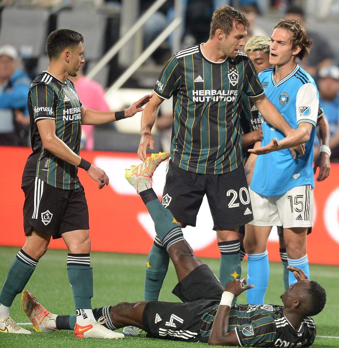 Charlotte FC Ben Bender is confronted by members of the LA Galaxy as he was assisting an LA Galaxy player stretch out during second half action at Bank of America Stadium in Charlotte, NC on Saturday, March 5, 2022. The LA Galaxy defeated Charlotte FC 1-0.