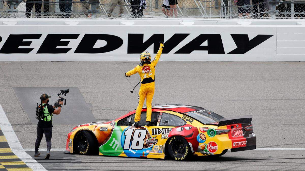 Kyle Busch, center, reacts after winning a NASCAR Cup Series auto race at Kansas Speedway in Kansas City, Kan., Sunday, May 2, 2021. (AP Photo/Colin E. Braley)