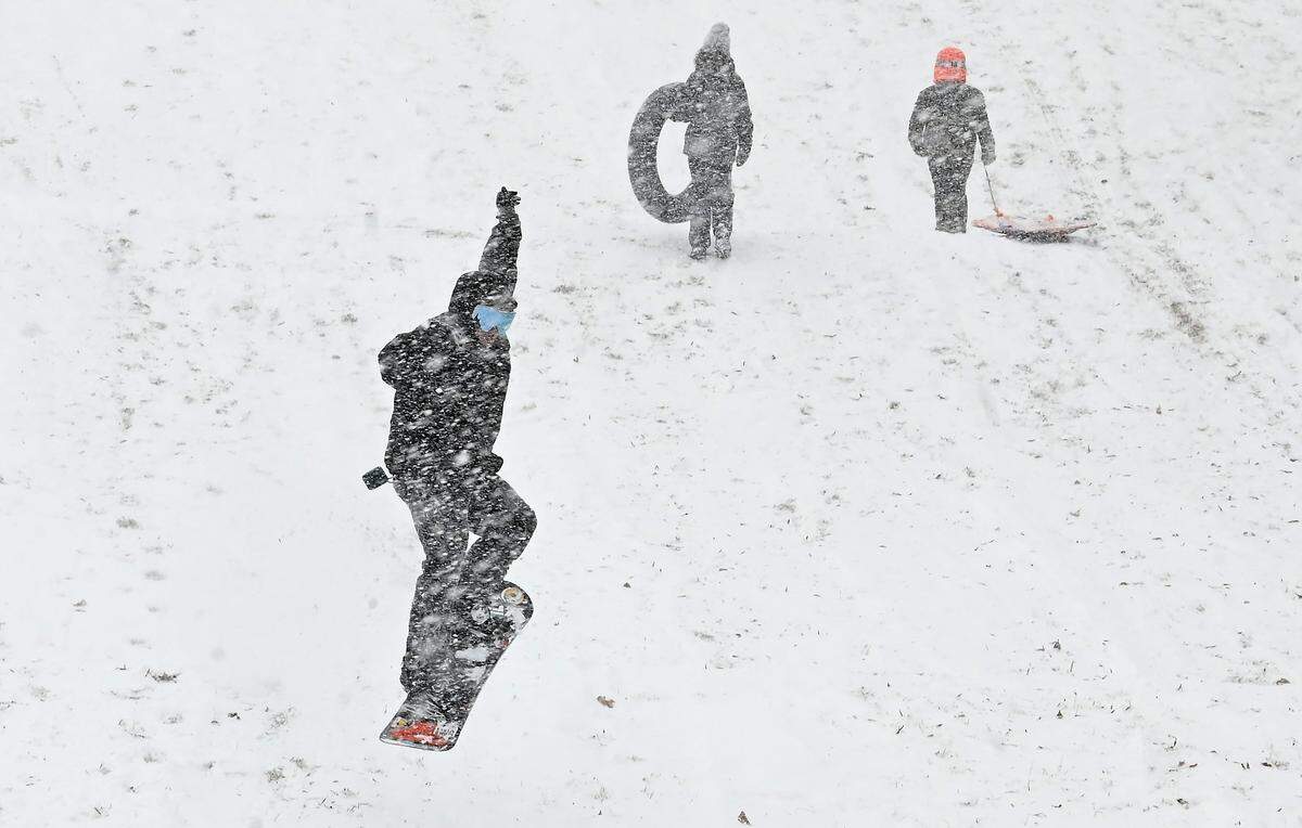 Enjoying the fresh snow, Dominic Sansottaon catches air off a hill at Veterans Park in Charlotte, NC on Saturday, January 31, 2026.