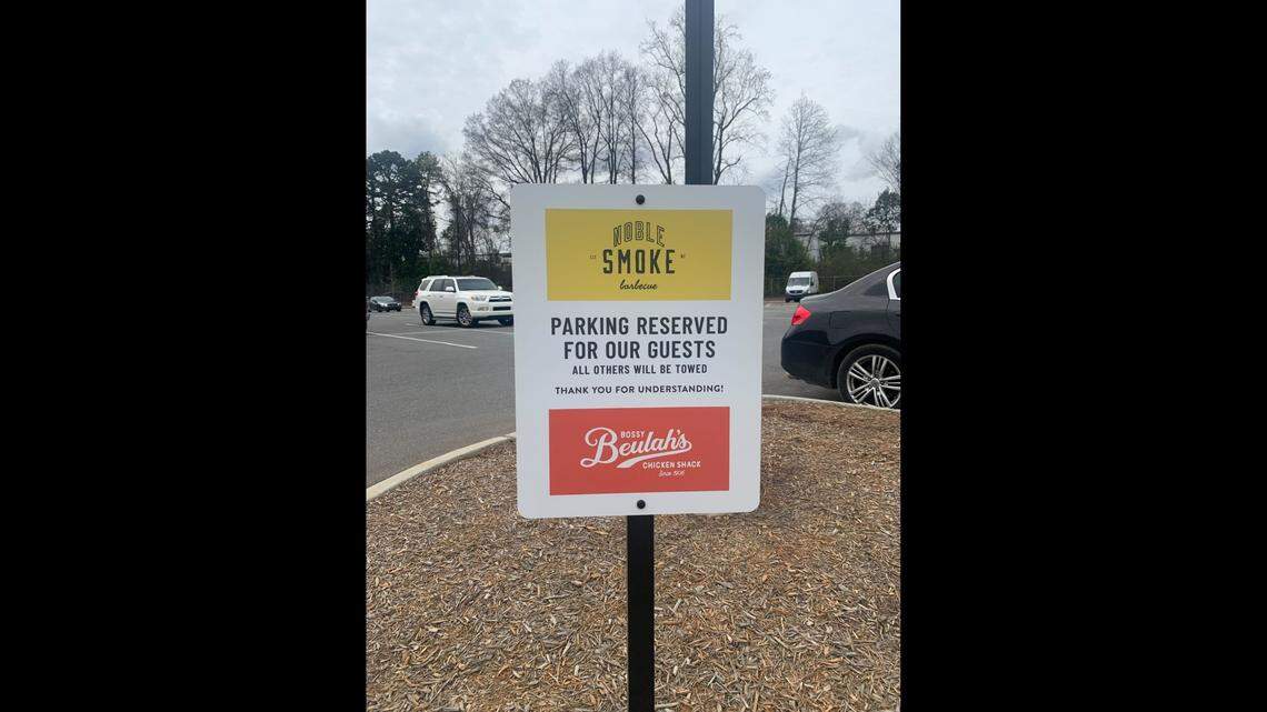 The signs, which were removed on Tuesday, prohibited The Good Life’s customers from parking in the shared lot.