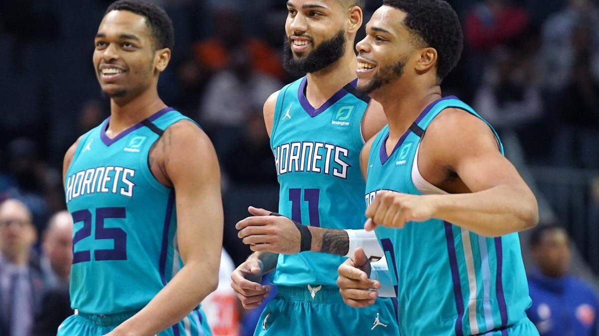 Charlotte Hornets forward P.J. Washington Jr., left, forward Cody Martin, center and forward Miles Bridges, right, smile as they head to the bench leading the New York Knicks during second half action on Tuesday, January 28, 2020 at Spectrum Center in Charlotte, NC. The Hornets defeated the Knicks 93-89.